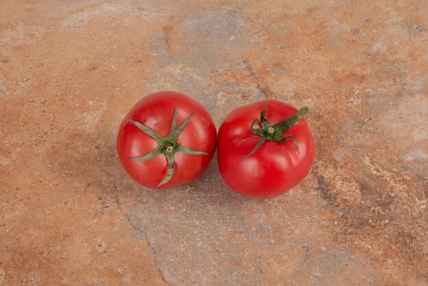 Zwei frische Tomaten lokalisiert auf Marmortisch.