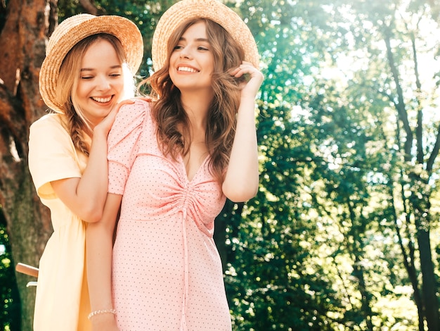 Zwei junge schöne lächelnde Hippie-Frau im trendigen Sommerkleid