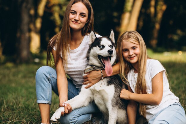 Zwei Schwestern mit ihrem Hund im Park