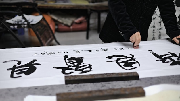 1571: um calígrafo chinês treina suas habilidades em papel branco. caligrafia shuyuanmen str-xian-china