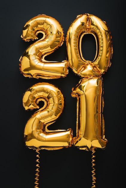 2021 Feliz año nuevo texto de globos de aire dorado con cintas en formato vertical negro.