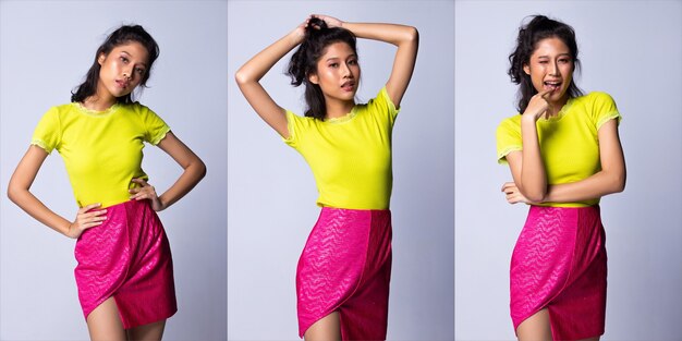 20er Jahre junge asiatische Frau als Model tragen grünes Hemd und Neon-Rosa-Kurzrock mit Silikon-Pink-Handtaschen-Kupplung, Studiobeleuchtung grauer Hintergrund isoliert, Collage-Gruppenpaket-Porträt