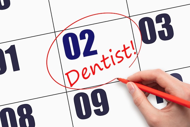 2do día del mes Texto escrito a mano DENTISTA y circulando la fecha del calendario