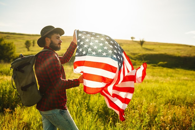 4. Juli Amerikanische Flagge Patriotischer Feiertag Reisender mit der Flagge Amerikas Schönes Sonnenuntergangslicht