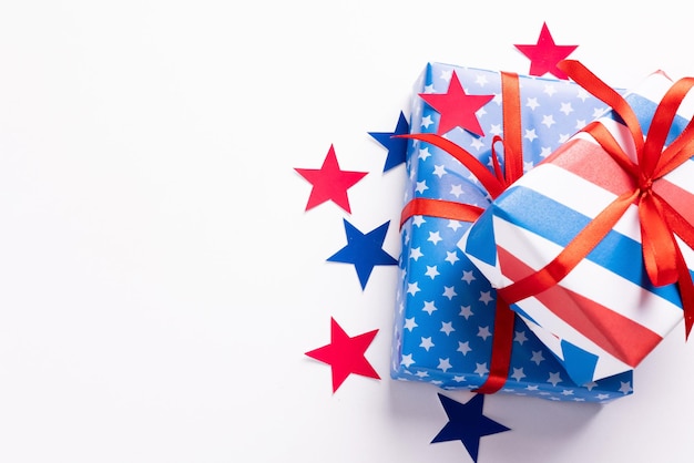 4 de julio Día de la Independencia de los Estados Unidos Feliz Día de la Independencia Decoraciones de papel de confeti de estrellas rojas, azules y blancas sobre fondo blanco Banner de espacio de copia de vista superior endecha plana