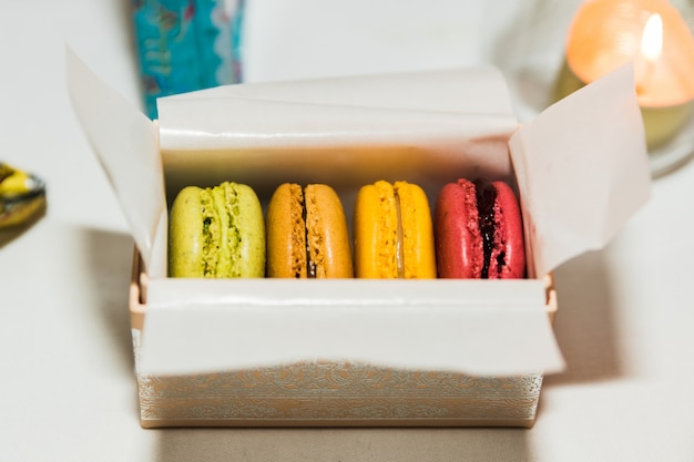 4 macarons em uma caixa de presente decorada