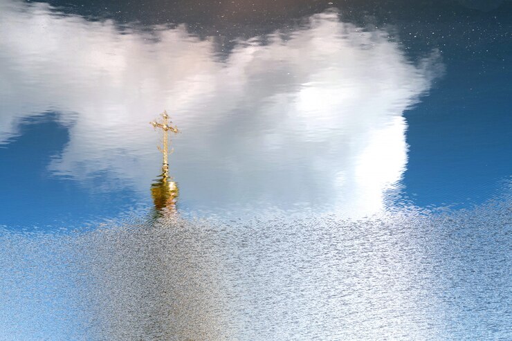 Foto a abóbada dourada e a cruz ortodoxo refletiram na superfície da água.