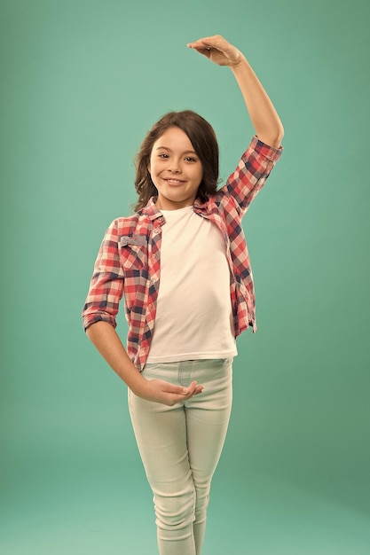 A bailarina feliz demonstra a posição da mão jovem dançarina talentosa imagina que ela é prima estudo na escola de balé criança adora dançar prática de menina pequena em atividades de estúdio de dança para crianças