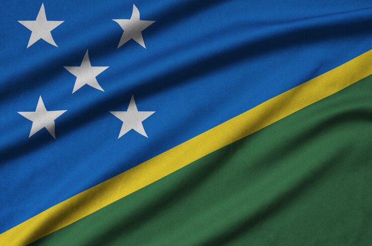 Foto a bandeira das ilhas salomão é retratada em um tecido esportivo com muitas dobras.