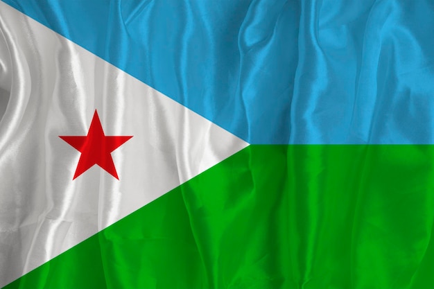 A bandeira do Djibouti em um fundo de seda é um grande símbolo nacional Textura de tecido O símbolo oficial do estado do país