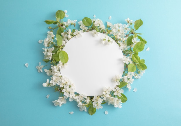 A composição de flores de cerejeira e brancas é forrada com moldura ao redor