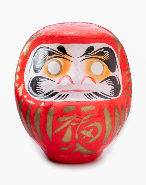 Foto a daruma é uma boneca tradicional japonesa um símbolo de perseverança, sucesso e sorte