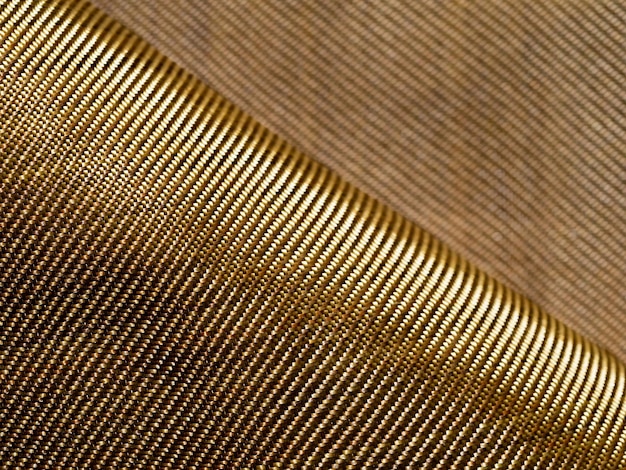 A dobra do material à prova de balas de tecido dourado aramida Fundo de kevlar de aramida Textura e padrão de kevlar dourado