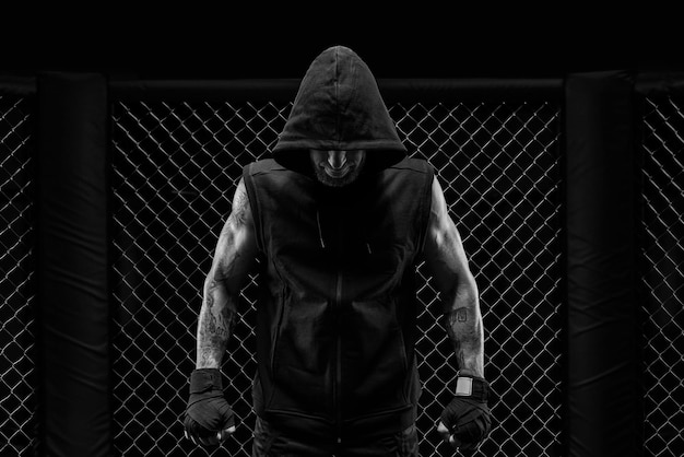 A dramática imagem em preto e branco do lutador de MMA Fotografia em um verdadeiro octógono lutador brutal mídia mista