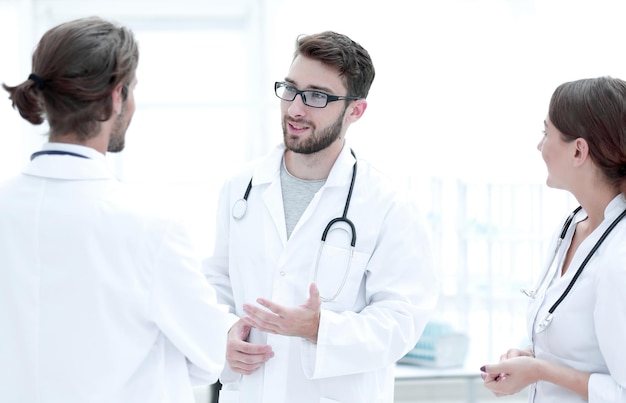 A equipe médica discute em um quarto de hospital moderno