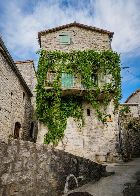 Foto a estreita rua de paralelepípedos da vila medieval de balazuc, no sul da frança (ardeche)