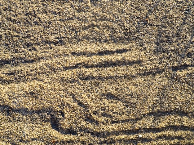 A estrutura do material Superfície de areia irregular Sob seus pés Fundo marrom