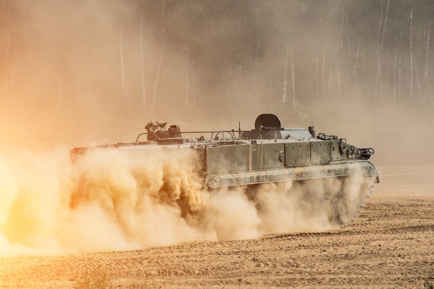 A frente do tanque, cavalgando na poeira.