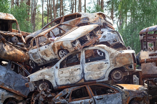 A invasão russa da ucrânia em 2022 destruiu e incendiou carros carros foram espancados com estilhaços e queimados cemitério de automóveis irpensky as consequências da guerra em uma cidade pacífica perto de kyiv