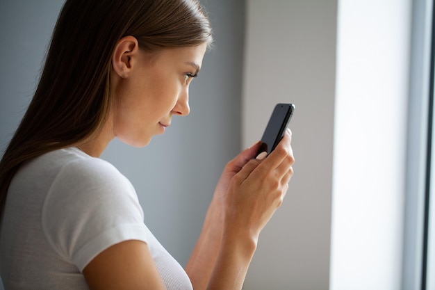 A jovem não desvia o olhar do telefone