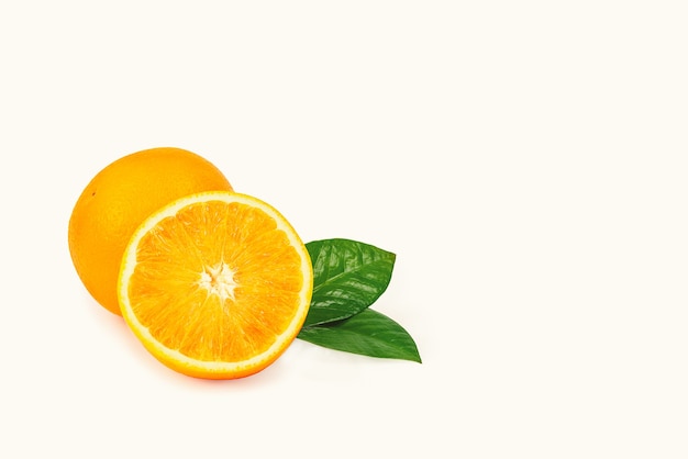 A laranja está isolada. Fruta inteira e metade com folhas em um fundo branco. Com uma sombra.