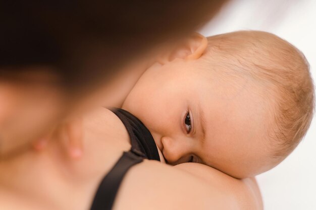 A mãe amamenta o bebê antes de ir para a cama. vista superior, foco seletivo no rosto do bebê