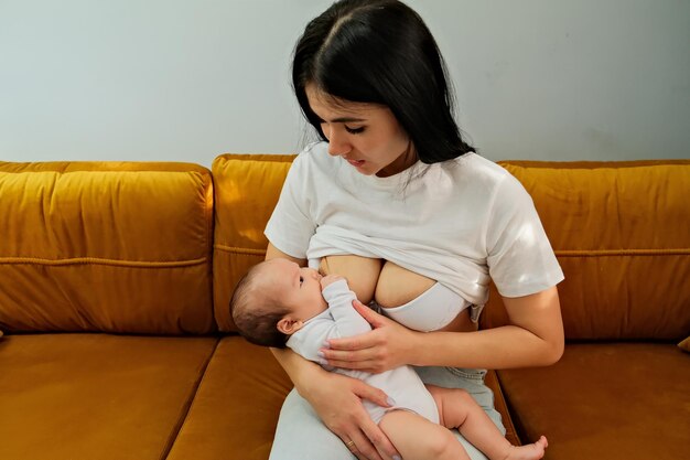 A mãe segura o bebê nos braços alimentando um recém-nascido com leite materno a mãe está amamentando o leite materno natural