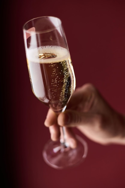 A mão de uma mulher segura uma taça de champanhe na mão