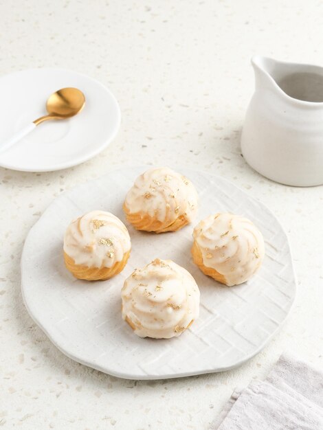 A massa choux contém apenas farinha de água com manteiga e ovos Pastéis choux com cobertura de chocolate