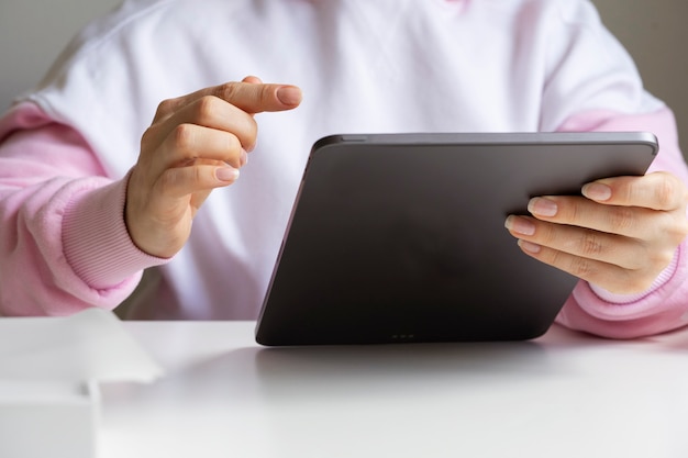 A menina olha para o novo tablet, toca a tela com o dedo.