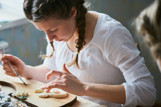 Foto a menina pinta a massa artesanal