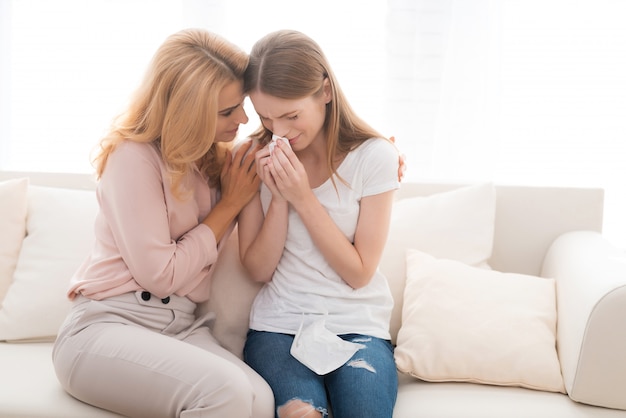 Foto a mulher consola a filha adolescente infeliz em casa.