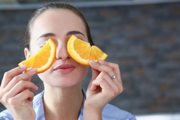 Foto a mulher de sorriso moreno bonita come a laranja cortada