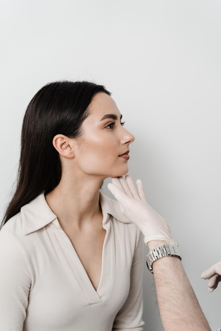 Foto a otoplastia é a remodelação cirúrgica do pavilhão auricular ou da orelha externa para corrigir uma irregularidade e melhorar a aparência o médico cirurgião examina a orelha da menina antes da cirurgia plástica de otoplastia