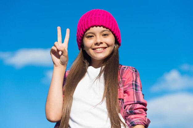 A paz será vitoriosa. criança feliz show v assinar céu ensolarado. dia da paz mundial. infância pacífica. 21 de setembro. amor e boa vontade. futuro brilhante. conceito de pacifismo.