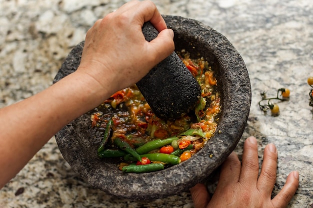 A pessoa hispânica faz um molho molcajete tradicional