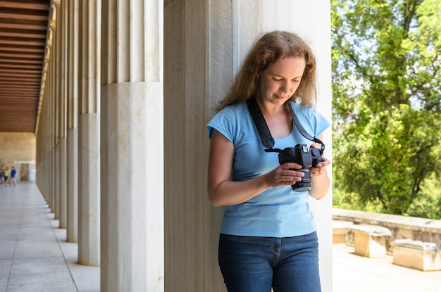 A pessoa joga fotos na câmera em colunas gregas antigas Atenas Grécia