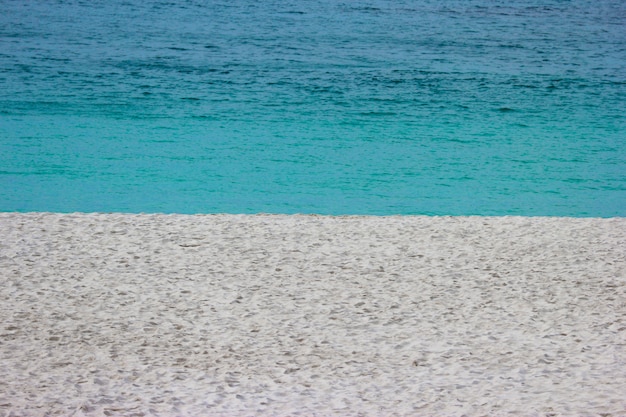 A praia branca da areia e o azul acenam o mar na praia de shirahama.