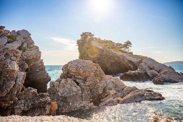 A praia e as falésias na ilha de são nicholas em budva montenegro paradise praia em um islan ...