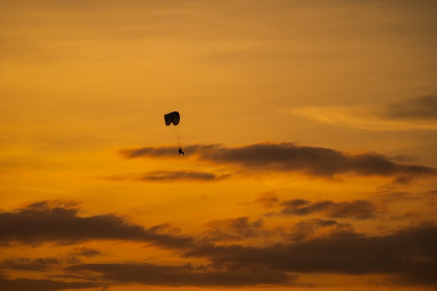 A silhueta do paramotor ao pôr do sol