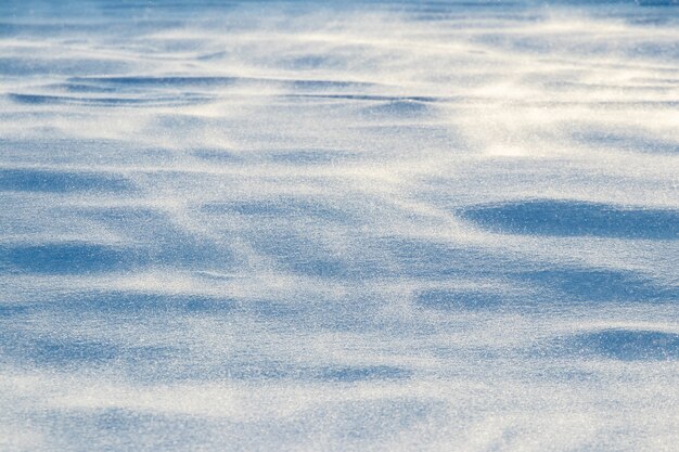 A superfície da neve após uma nevasca pela manhã com um vento forte