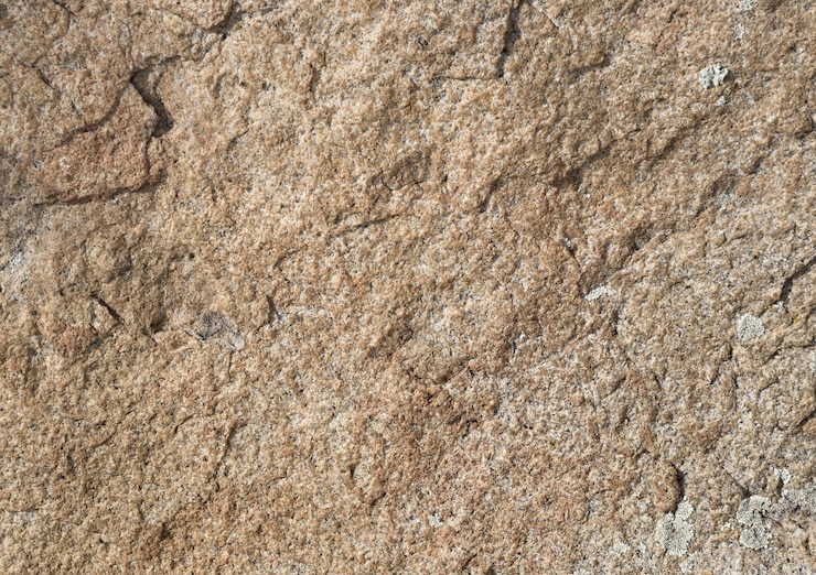 Foto a textura da superfície da areia do granito e a textura dos estilhaços de cores rosa da pedra