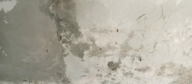 A textura da velha parede de cimento de tinta cinzenta