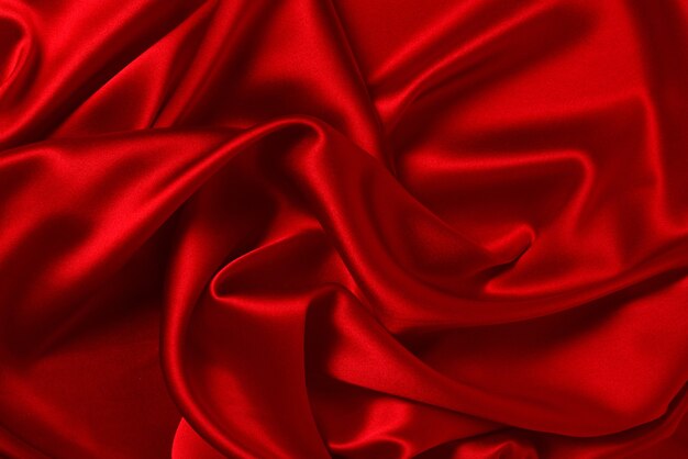 A textura de tecido de seda vermelha ou cetim luxuoso pode ser usada como fundo abstrato.