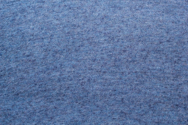 A textura de um fundo azul de tecido de lã tricotado