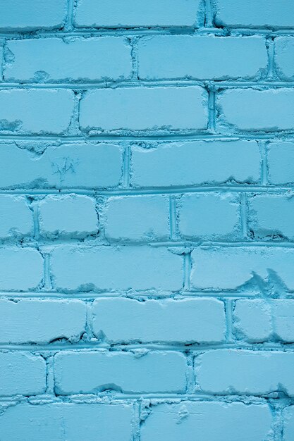 Foto a textura de uma parede de tijolos pintada em foto vertical azul