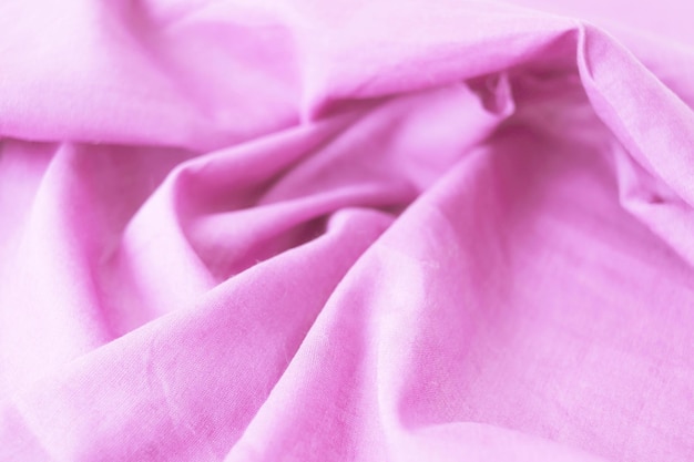 A textura do algodão de tecido natural rosa dobra a vista superior