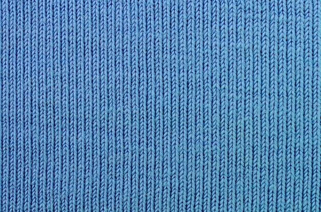 A textura do tecido na cor azul. Material para fazer camisas e blusas