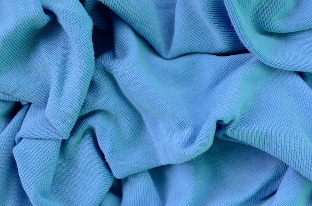 A textura do tecido na cor azul. Material para fazer camisas e blusas