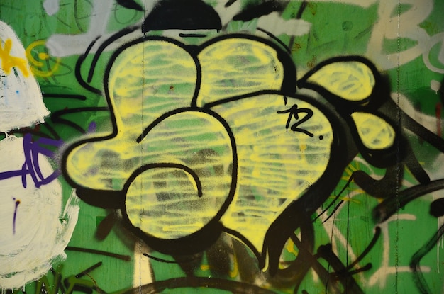 A velha parede pintada em cor graffiti desenho pinturas de aerossol verde imagem de fundo sobre o tema de desenho graffiti e arte de rua